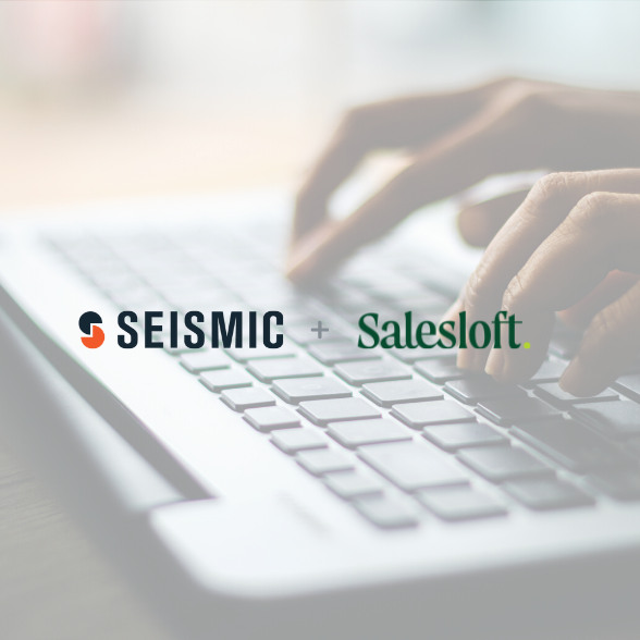 Seismic and Salesloft logos over a background image of hands on a keyboard