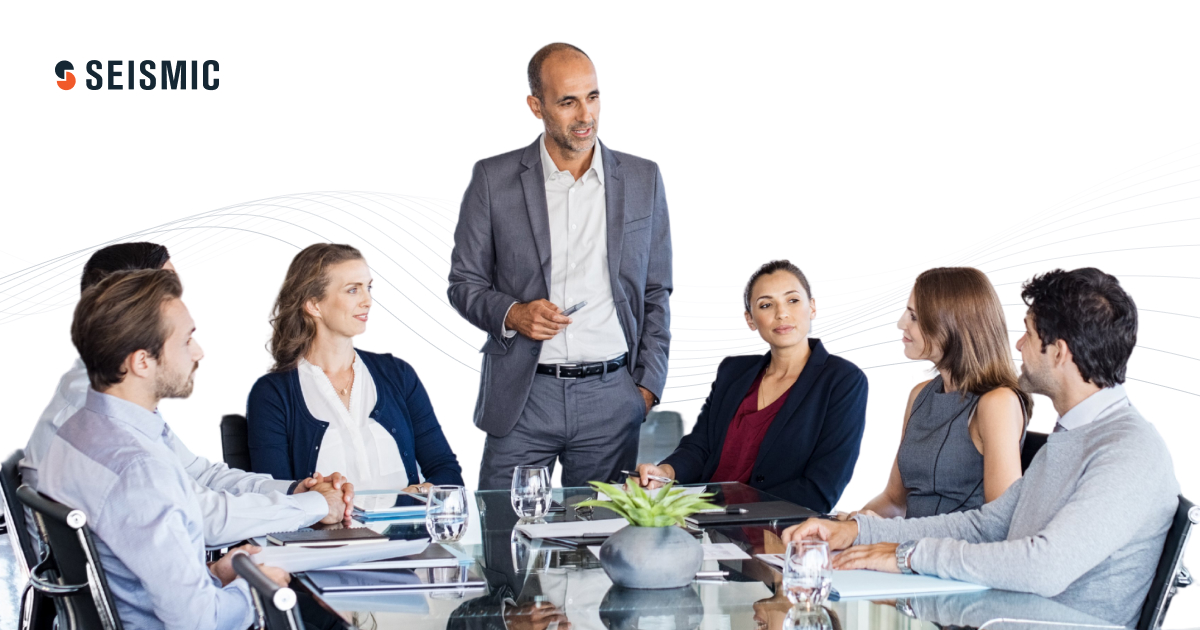 A group of coworkers gathered around a conference table.