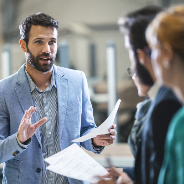 A worker talking to three coworkers.