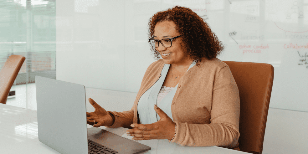 Smiling woman looking at her laptop.