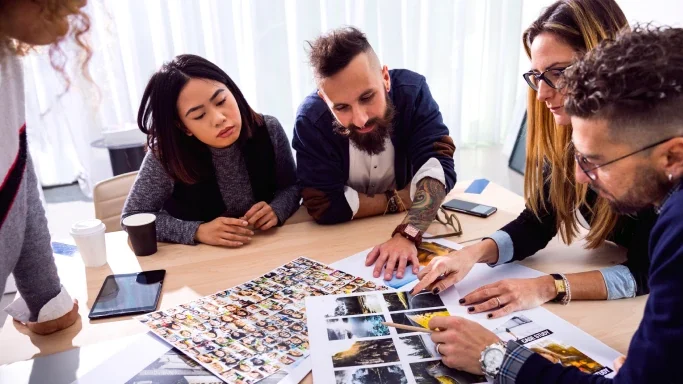 Office workers choosing images to use.