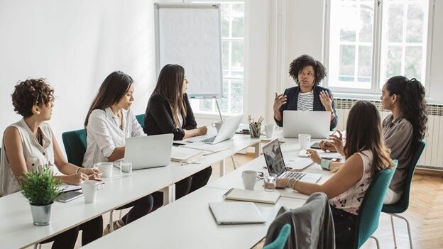 A small group of business people in a training meeting.