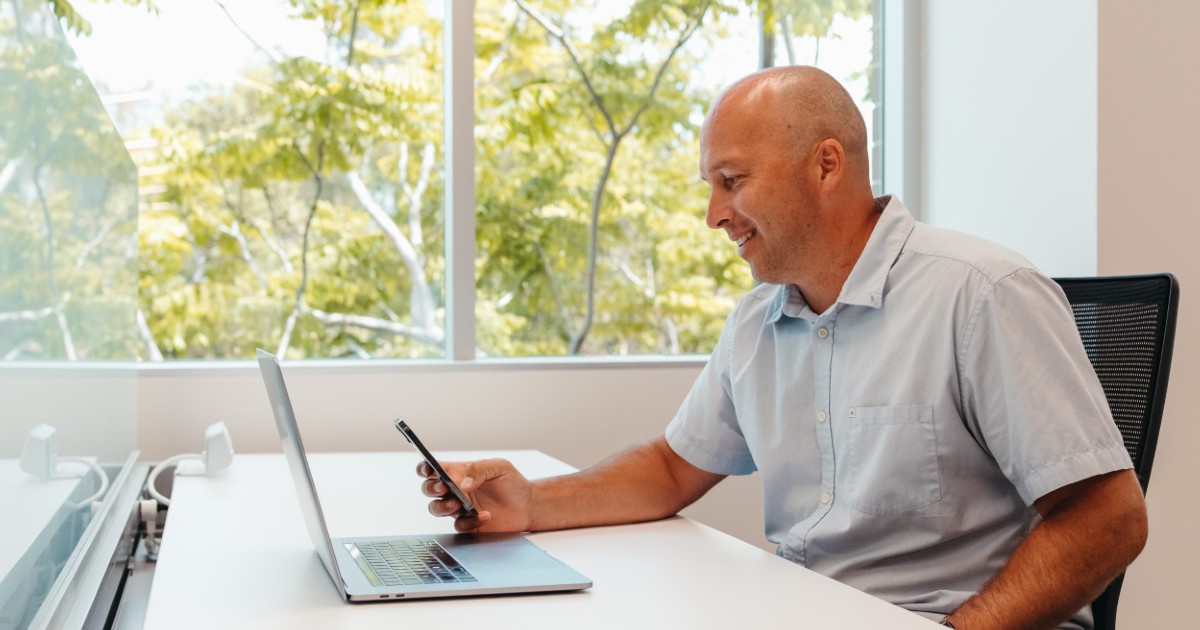 A man looks at his cell phone.