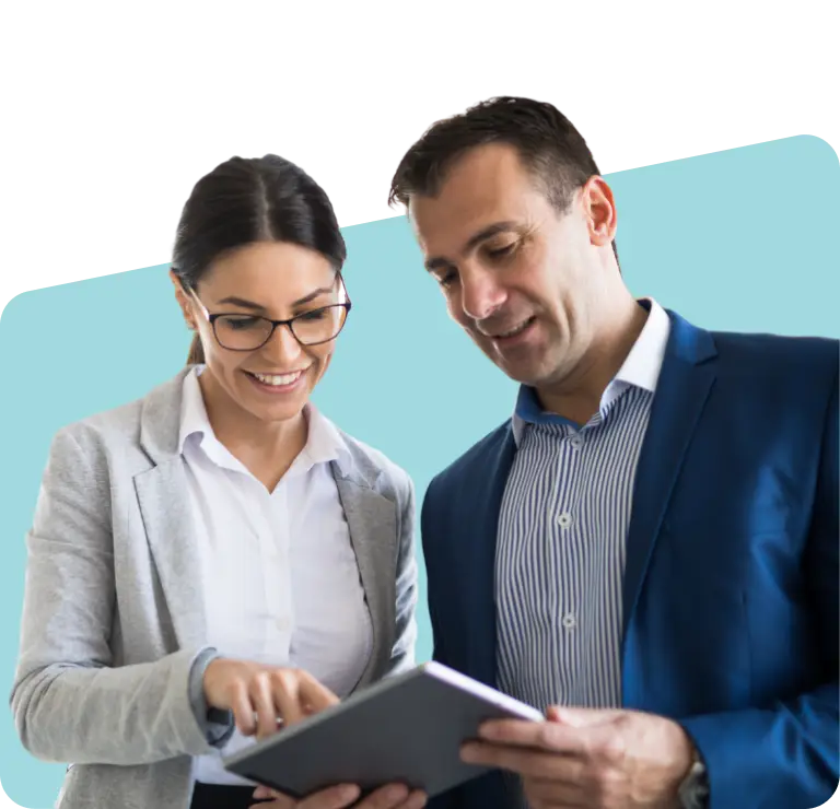 Two smiling people looking at a tablet.
