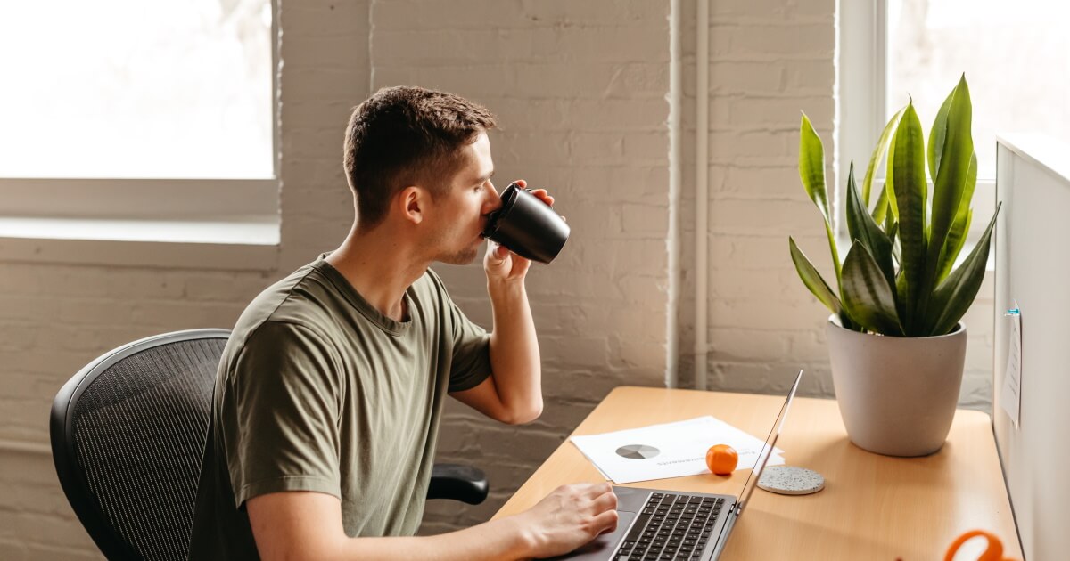 Man drinking coffee while browsing the web.