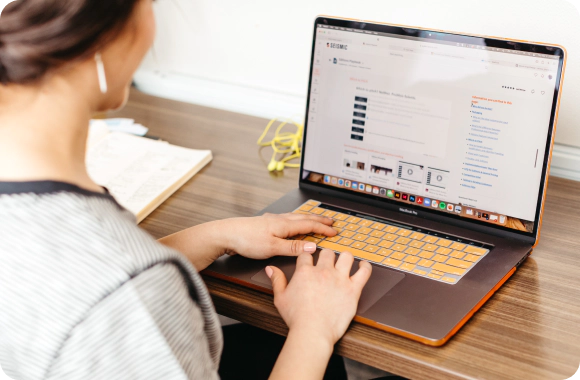 Office worker typing on a laptop.